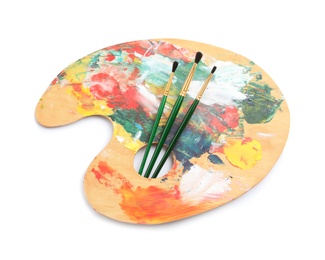 Wooden palette with brushes on white background, top view. Painting equipment for children