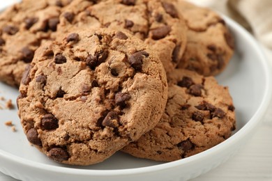 Photo of Delicious chocolate chip cookies on plate, closeup