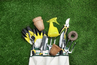 Photo of Flat lay composition with gardening tools on green grass