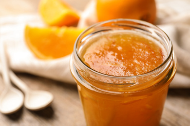 Homemade delicious orange jam on table, closeup view