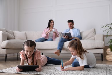 Family in living room with comfortable sofa, focus on children