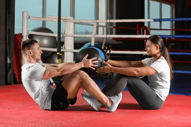 Young couple working out in modern gym