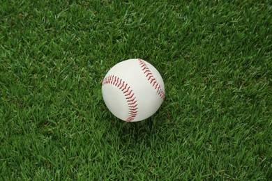 Photo of Baseball ball on green grass, top view. Sports game