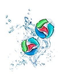 Laundry capsules and splashing water on white background. Detergent pods
