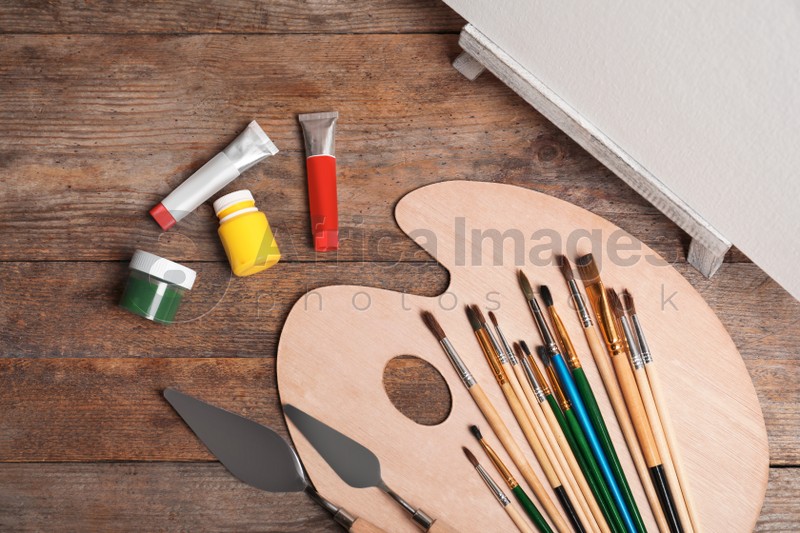 Set of painting tools for children on wooden background, top view
