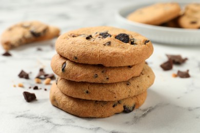 Delicious chocolate chip cookies on white marble table