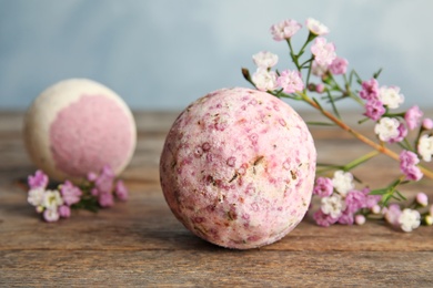 Photo of Bath bomb and flowers on wooden table