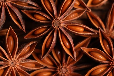 Aromatic anise stars on wooden table, flat lay