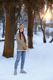 Photo of Beautiful young woman enjoying winter day outdoors