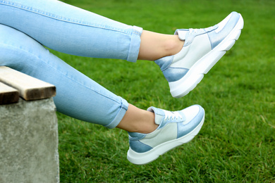 Woman wearing comfortable stylish sneakers outdoors, closeup