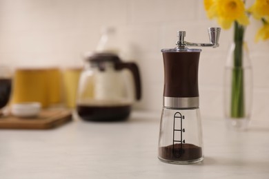 Manual coffee grinder on counter in kitchen