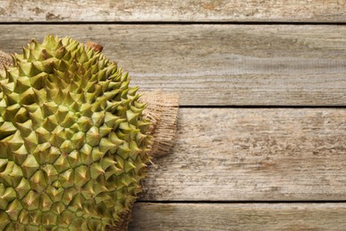 Ripe durian on wooden table, top view. Space for text