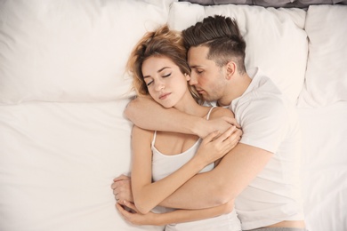 Lovely young couple sleeping in bed at home