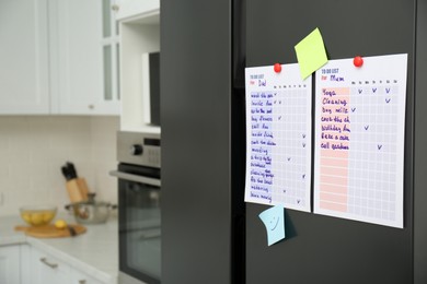 To do lists and sticky notes on fridge in kitchen. Space for text