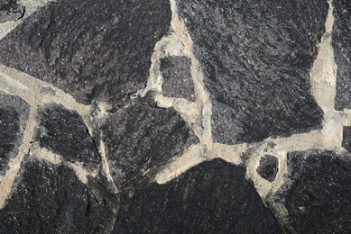 Texture of black stone surface as background, top view