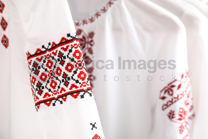 Beautiful shirts with different embroidery designs, closeup. Ukrainian national clothes