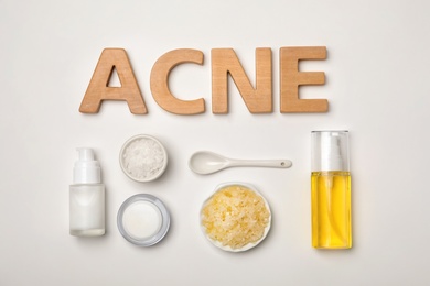 Word "Acne" and fresh ingredients for homemade problem skin remedy on white background