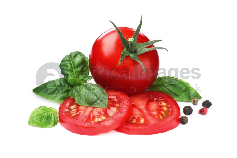 Photo of Fresh green basil leaves, spices with cut and whole tomatoes on white background, top view