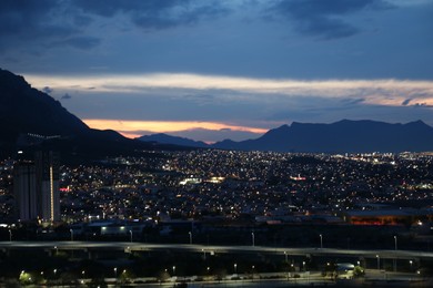 Photo of Picturesque view of city and mountains in evening