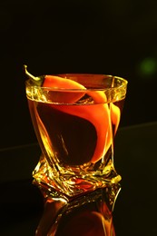 Red hot chili pepper and vodka on dark table