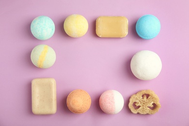 Photo of Flat lay composition with bath bombs, soap bars and space for text on color background