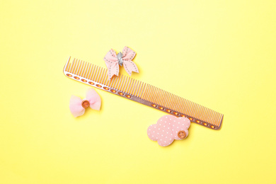 Flat lay composition with modern hair comb on yellow background