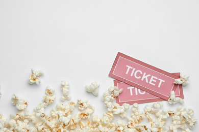 Popcorn and tickets on white background, top view. Cinema snack