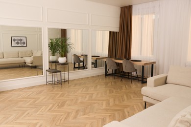 Modern living room with parquet flooring and stylish furniture