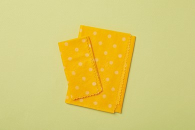 Beeswax food wraps on light green background, flat lay