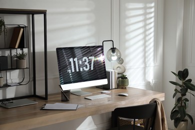 Modern computer and laptop on wooden desk in room. Interior design