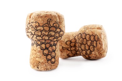 Two sparkling wine corks with grape images on white background
