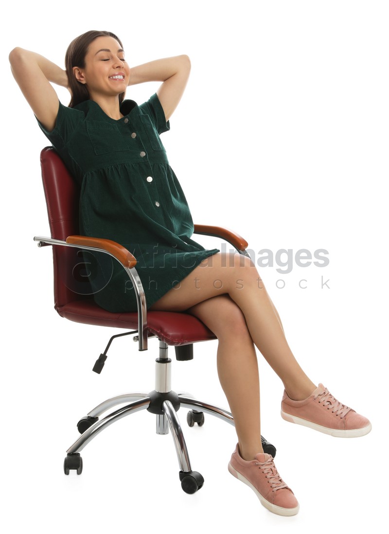 Young woman relaxing in comfortable office chair on white background