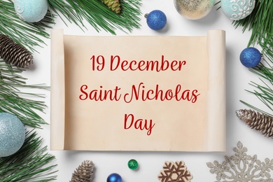 19 December Saint Nicholas Day. Christmas decor and paper on white background, flat lay