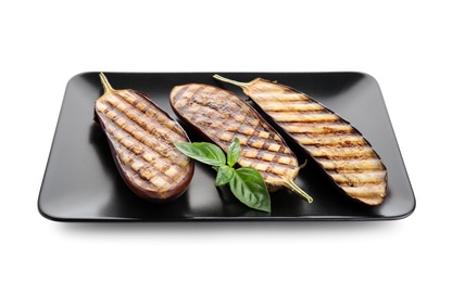 Delicious grilled eggplant halves with basil isolated on white