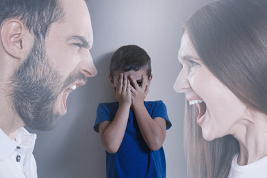Double exposure of sad little boy and his arguing parents
