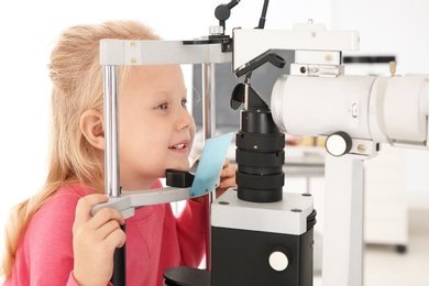 Little girl visiting children's doctor in clinic. Eye examination