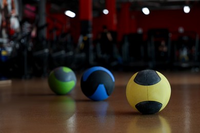 Medicine balls on floor in gym. Space for text