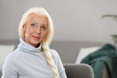Portrait of elegant mature woman at home. Space for text