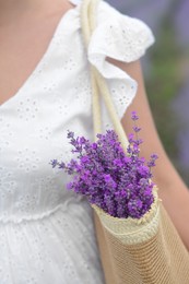 Woman with bag of beautiful lavender flowers outdoors, closeup