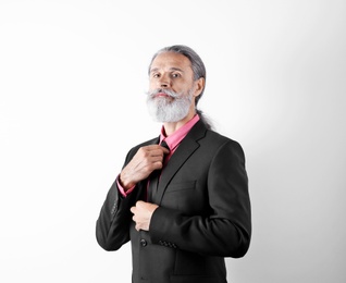 Handsome bearded mature man in suit on white background