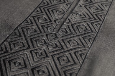 Black shirt with beautiful embroidery design as background, closeup. Ukrainian national clothes