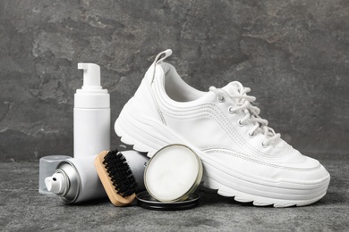Composition with stylish footwear and shoe care accessories on grey background