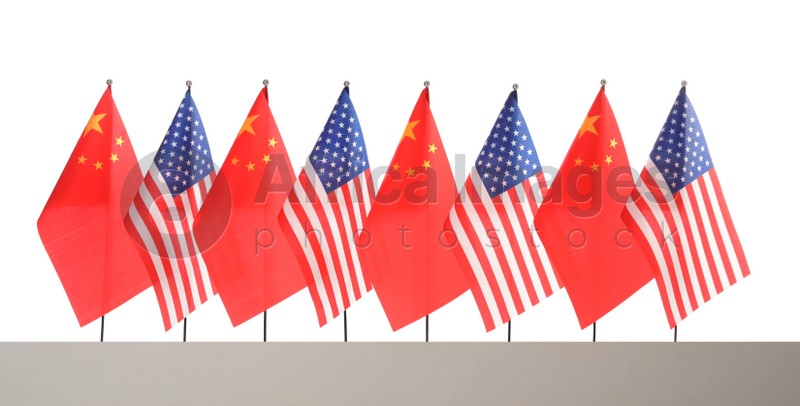 Many USA and China flags on white background. International relations