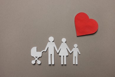 Paper family figures and red heart on light grey background, flat lay. Insurance concept