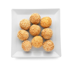 Photo of Plate of delicious sesame balls on white background, top view