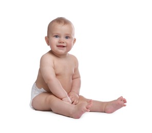 Cute baby in dry soft diaper sitting on white background