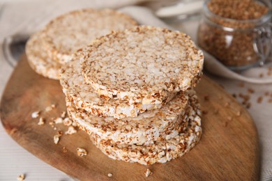 Stack of fresh crunchy rice cakes on white wooden table, closeup