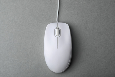 Modern wired computer mouse on grey background, top view