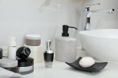 Camera hidden among different toiletries on table in bathroom