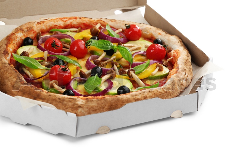 Photo of Delicious vegetable pizza in cardboard box on white background, closeup